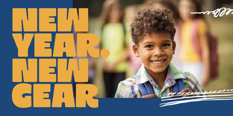 A smiling young boy with a bookbag. The words at the left: new year, new gear.