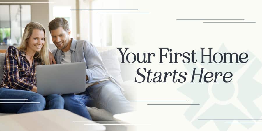 A couple sitting on their living room couch looking at a laptop.