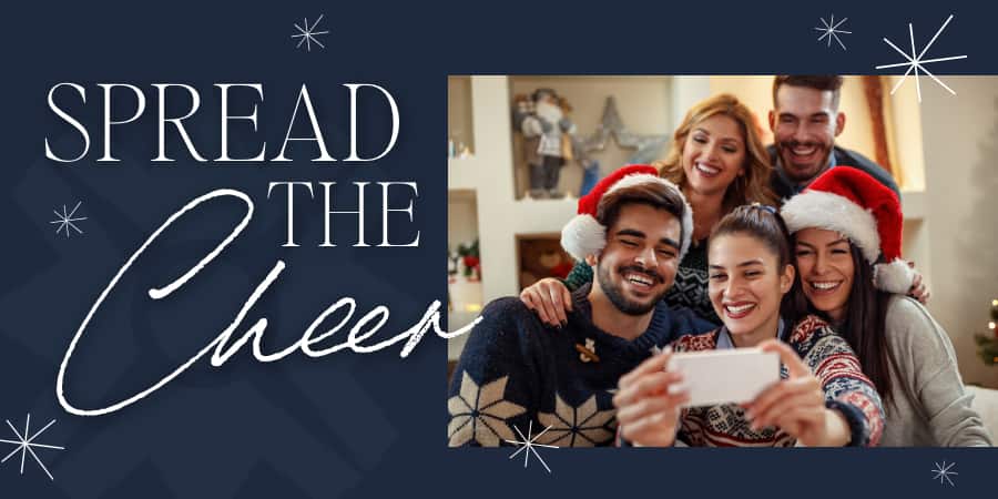 A group of smiling friends taking a selfie. At the left, the words: spread the cheer.