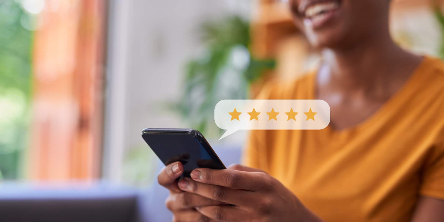 A woman holding completing a review with a smartphone.